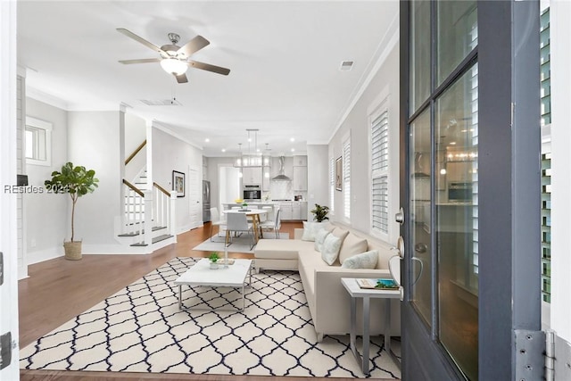 living room with crown molding, ceiling fan, and hardwood / wood-style floors