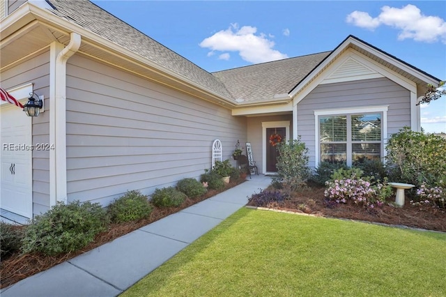 doorway to property featuring a lawn