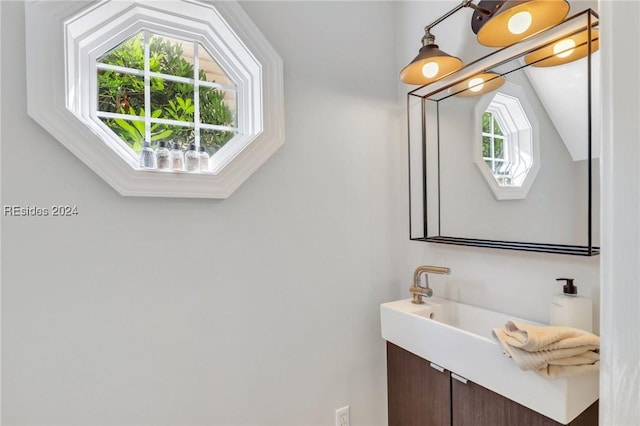 bathroom featuring vanity and lofted ceiling