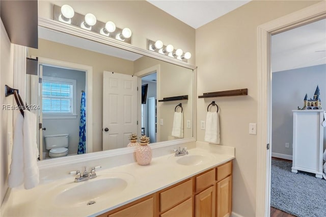 bathroom featuring vanity and toilet