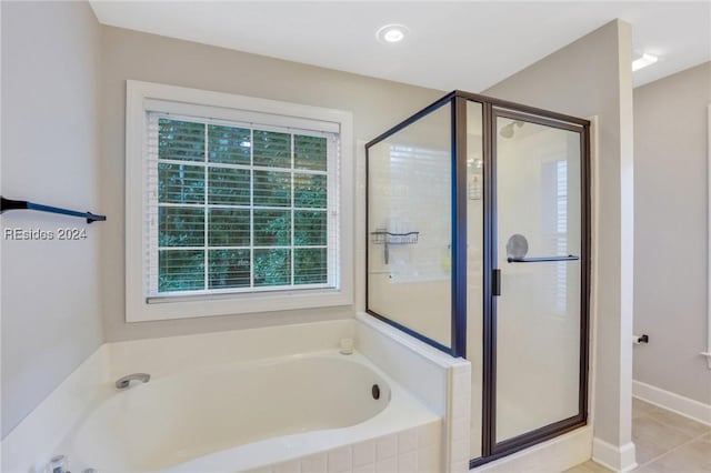 bathroom featuring tile patterned floors and separate shower and tub