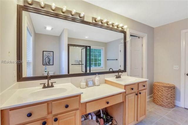 bathroom with tile patterned flooring and vanity