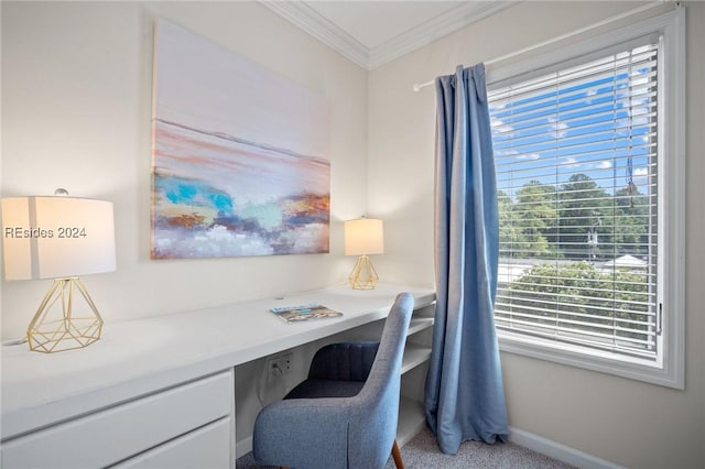 carpeted office space featuring ornamental molding and built in desk