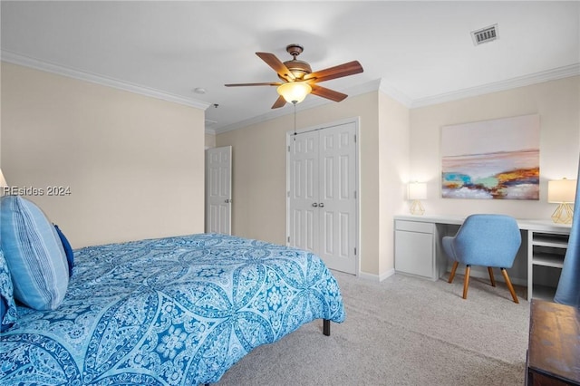 carpeted bedroom with ornamental molding, ceiling fan, and a closet