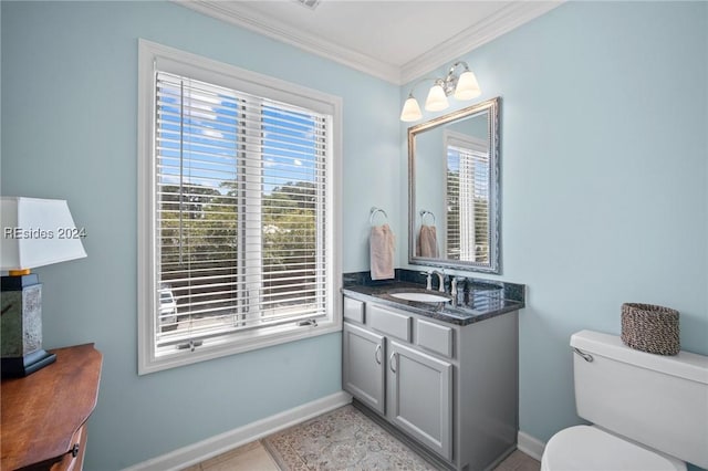 bathroom featuring vanity, tile patterned flooring, ornamental molding, and toilet