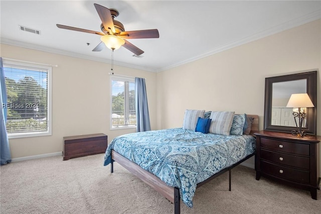 bedroom featuring light carpet, ornamental molding, and ceiling fan