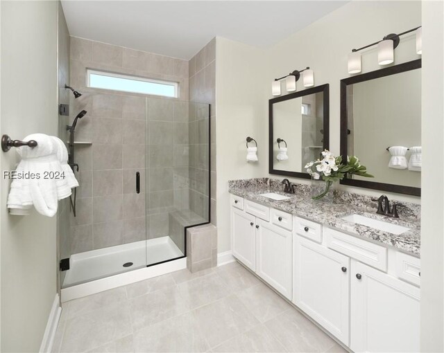 bathroom featuring vanity, tile patterned flooring, and a shower with door