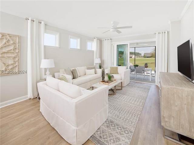 living room with ornamental molding, a wealth of natural light, light hardwood / wood-style floors, and ceiling fan