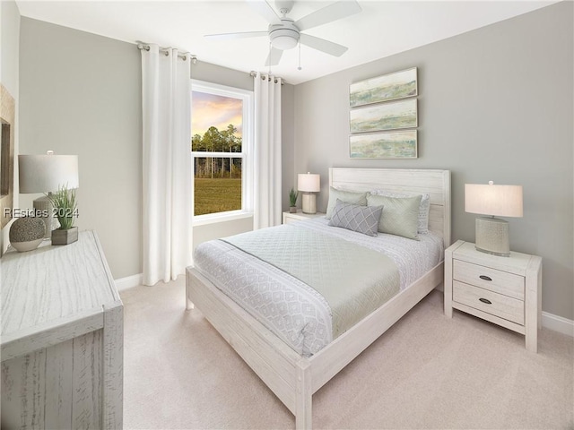 bedroom featuring light carpet and ceiling fan