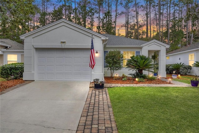 ranch-style house featuring a yard and a garage