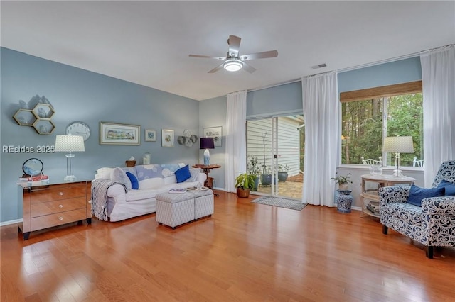 living room featuring ceiling fan and light hardwood / wood-style floors