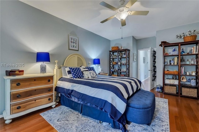 bedroom with dark hardwood / wood-style flooring and ceiling fan