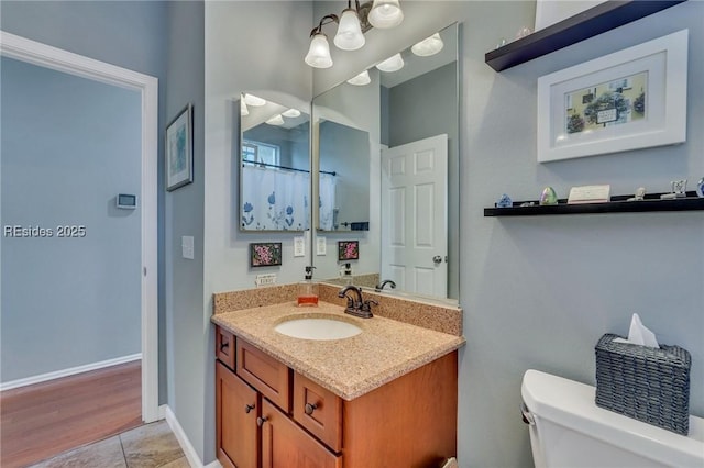 bathroom with vanity, tile patterned floors, and toilet