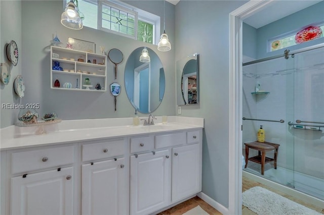 bathroom with vanity, tile patterned floors, and a shower with door