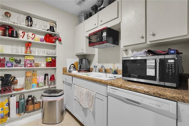 kitchen with stone counters, white cabinetry, sink, and white dishwasher