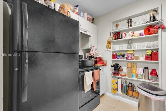 kitchen featuring light tile patterned floors, black appliances, and white cabinets