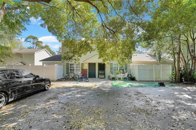 view of property hidden behind natural elements with a patio area