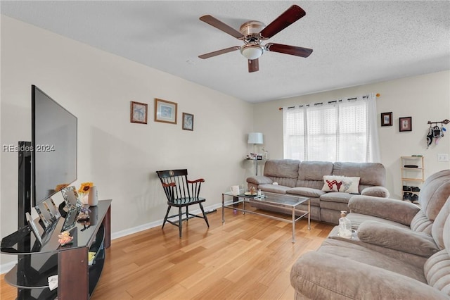 living room featuring hardwood / wood-style flooring, a textured ceiling, and ceiling fan