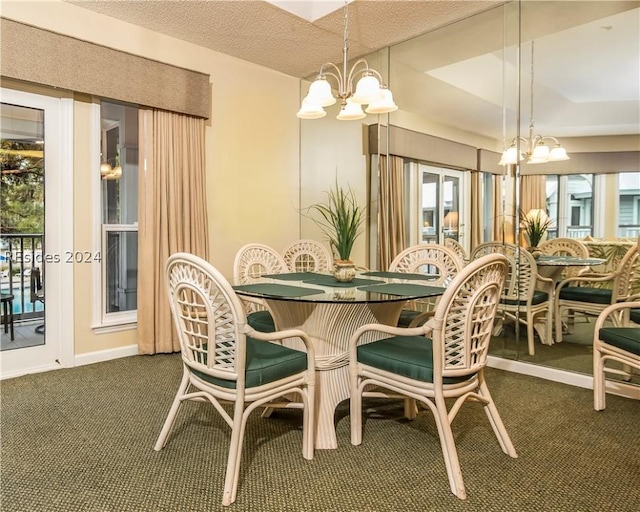 dining area featuring a notable chandelier, a textured ceiling, and dark colored carpet