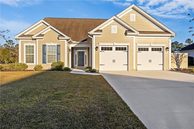 view of front of property with a garage and a front lawn