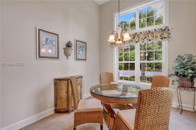 dining area featuring a chandelier and light tile patterned floors