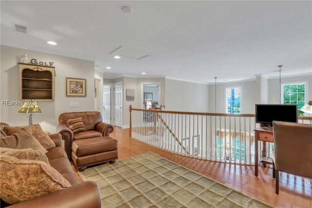 living room featuring crown molding and wood-type flooring