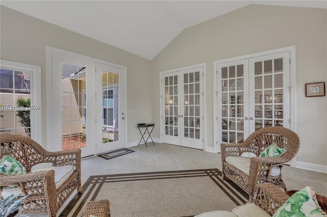 sunroom featuring a wealth of natural light, vaulted ceiling, and french doors