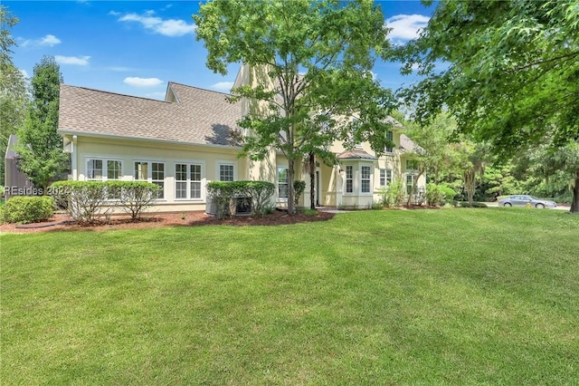 rear view of property with a yard