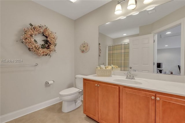 bathroom with vanity, tile patterned floors, toilet, and walk in shower