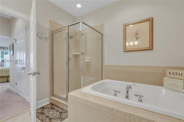 bathroom featuring shower with separate bathtub and tile patterned flooring