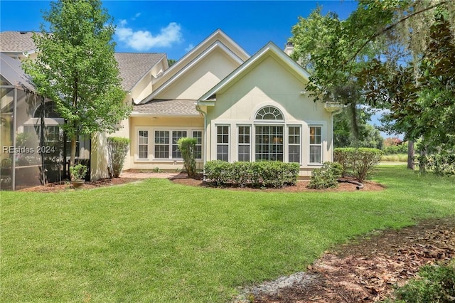 rear view of house with a yard