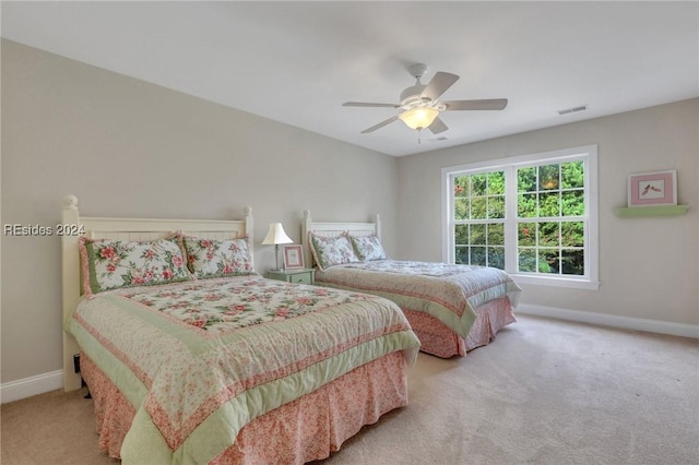 bedroom with light colored carpet and ceiling fan