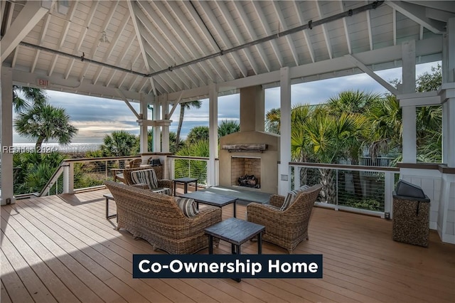 wooden deck with a gazebo and an outdoor fireplace