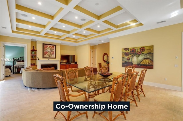 dining space with coffered ceiling, crown molding, and beamed ceiling