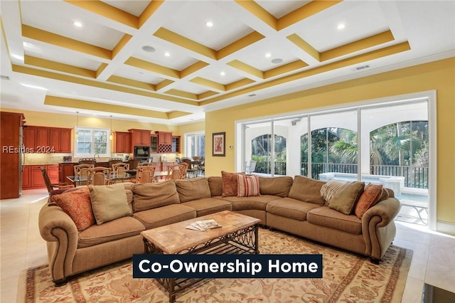 tiled living room with a healthy amount of sunlight, coffered ceiling, and beam ceiling