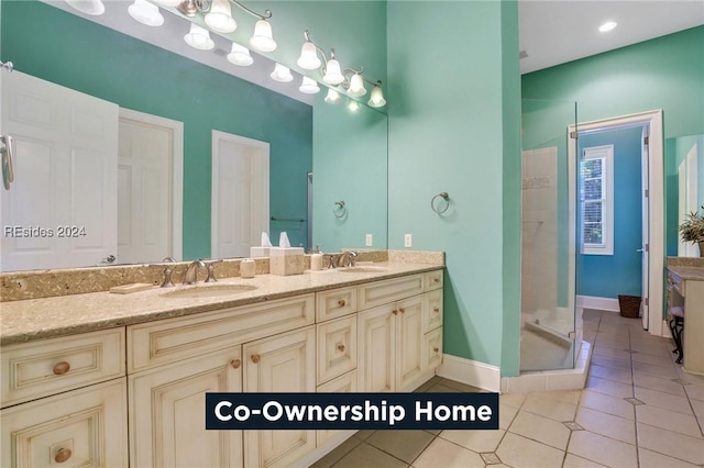 bathroom featuring vanity, tile patterned floors, and a shower with door