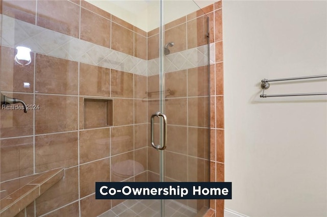 bathroom featuring a shower with door