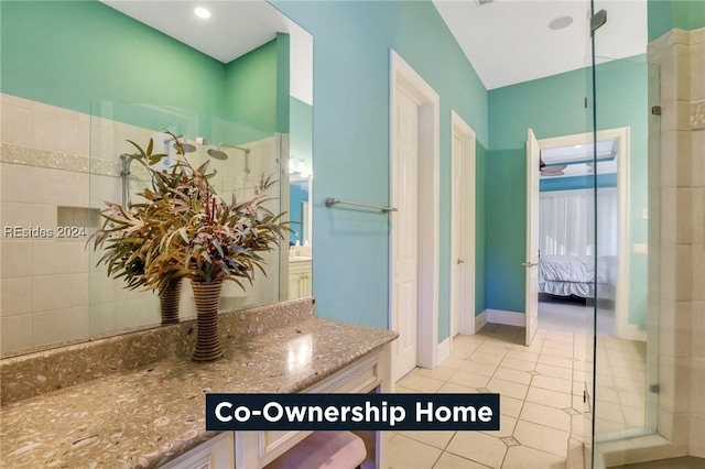 bathroom with an enclosed shower, vanity, and tile patterned floors