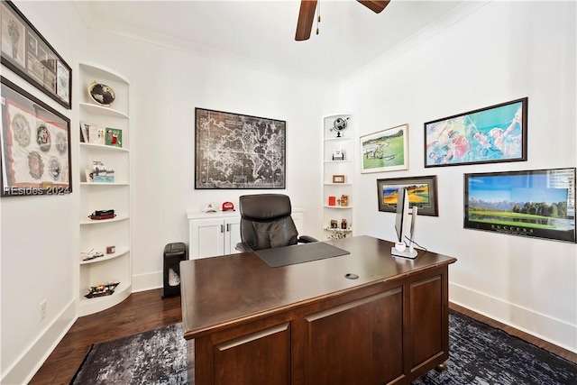 office area featuring crown molding, built in shelves, dark wood-type flooring, and ceiling fan