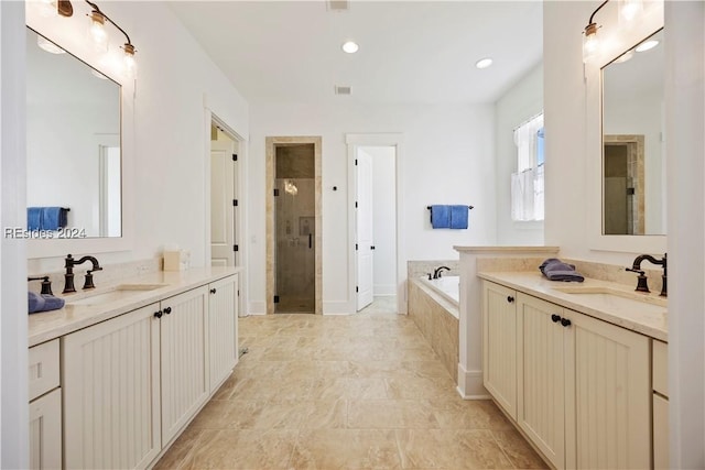 bathroom with vanity and separate shower and tub