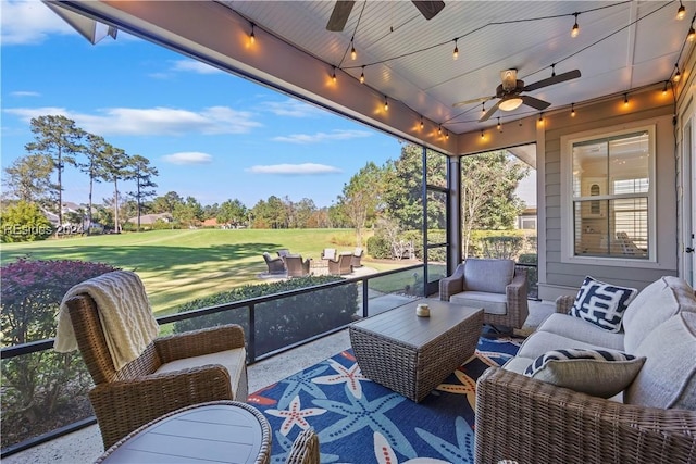 sunroom / solarium featuring ceiling fan