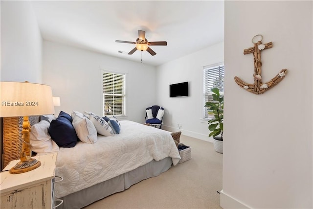 bedroom with multiple windows, carpet floors, and ceiling fan