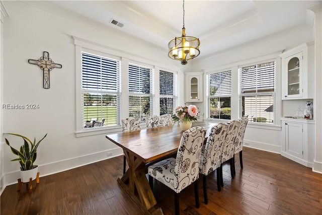 dining room featuring dark hardwood / wood-style flooring, a wealth of natural light, and a chandelier