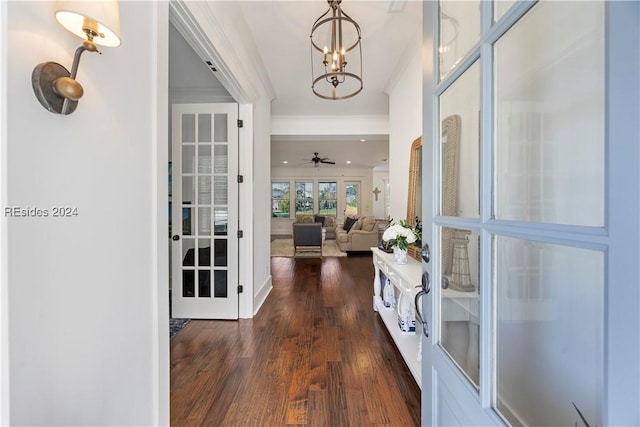 hallway featuring dark wood-type flooring and an inviting chandelier