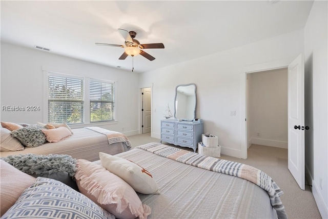 bedroom with light carpet and ceiling fan