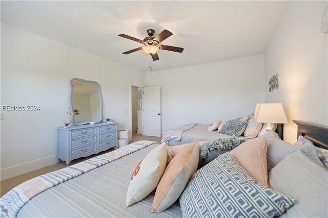 bedroom featuring light colored carpet and ceiling fan