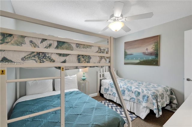 carpeted bedroom with a textured ceiling and ceiling fan