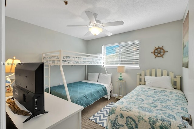 carpeted bedroom with a textured ceiling and ceiling fan