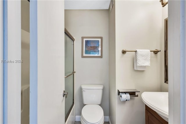 full bathroom featuring shower / bath combination with glass door, vanity, and toilet