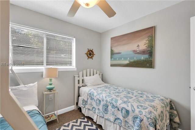 bedroom featuring multiple windows, carpet, and ceiling fan